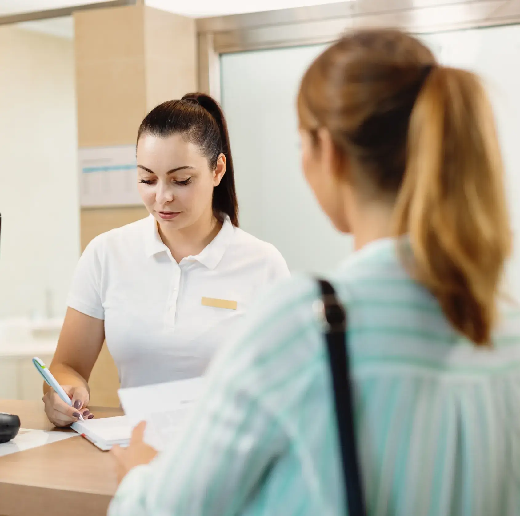 Patient at the frontdesk filling forms