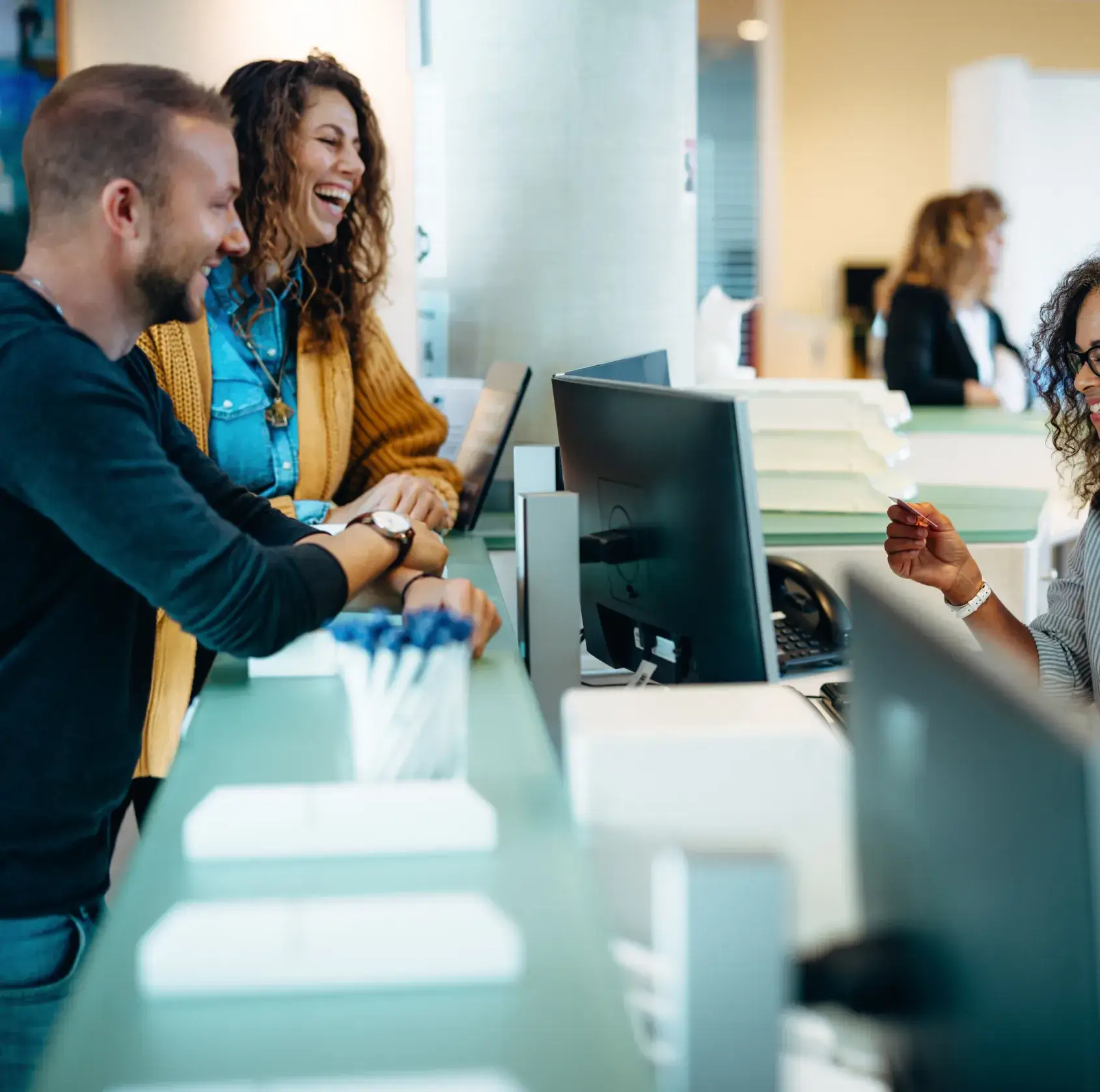 Patients at front desk paying dental services