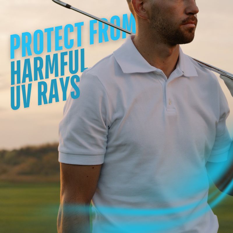 man in golf field, wearing a polo shirt, sun setting behind him
