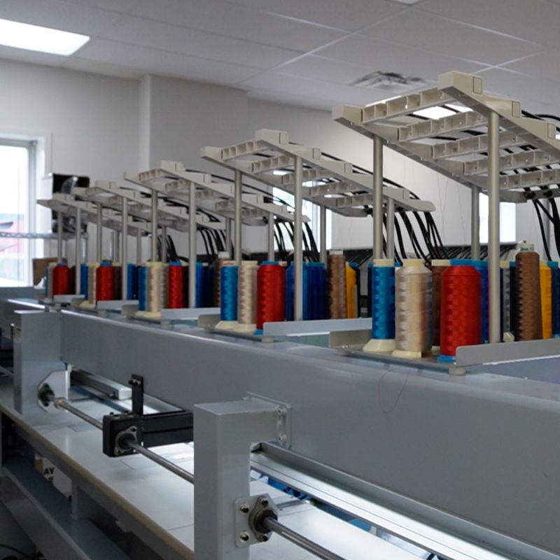 image of different coloured thread used to create the embroidered design on the garment