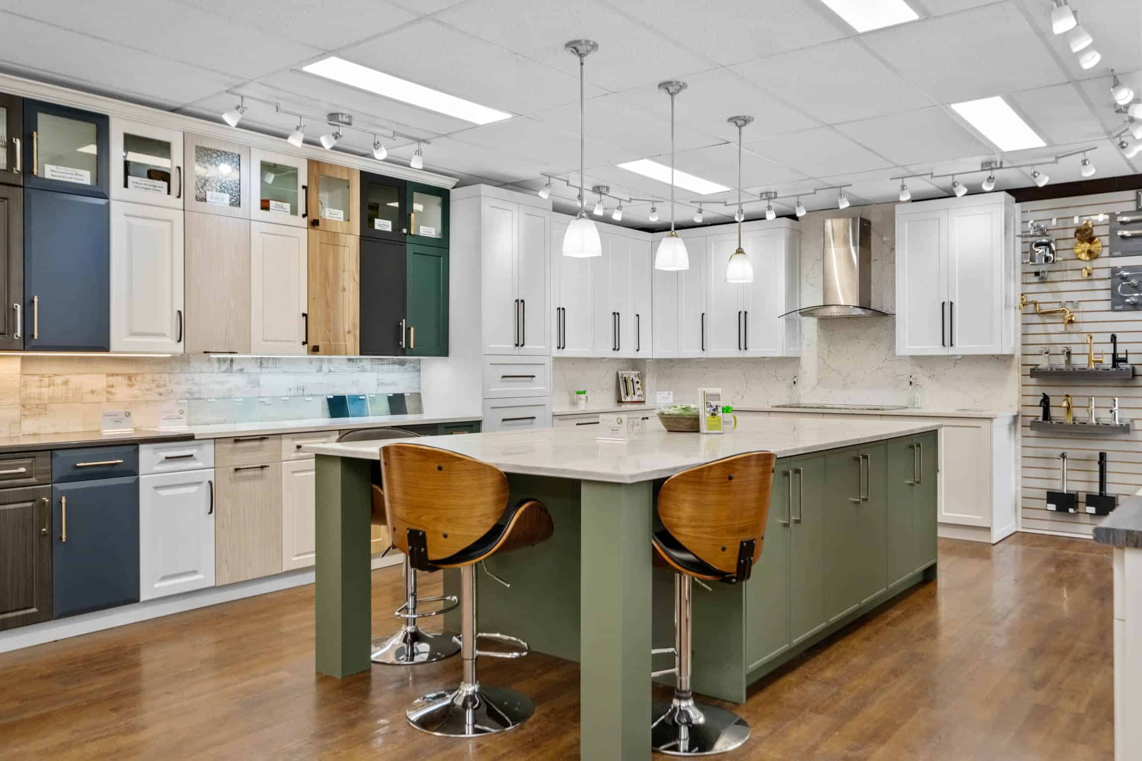 Sage green and white coloured kitchen cabinets