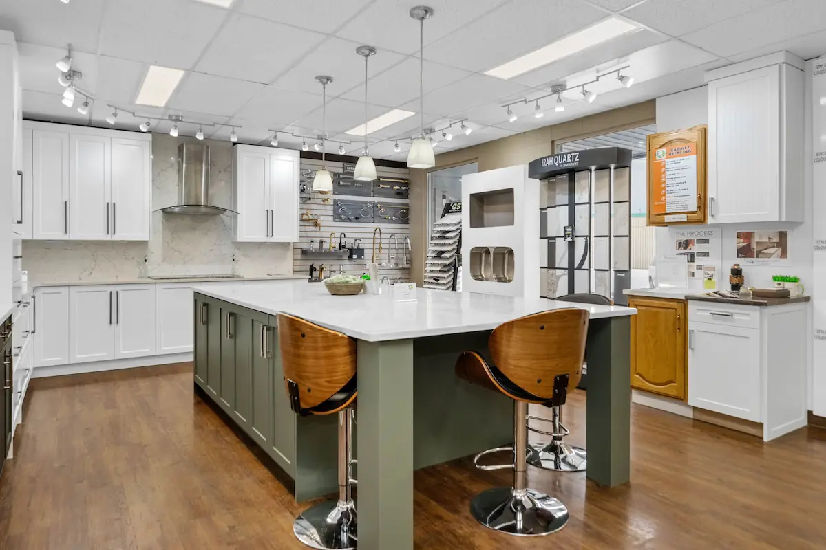 Sage green and white coloured kitchen cabinets