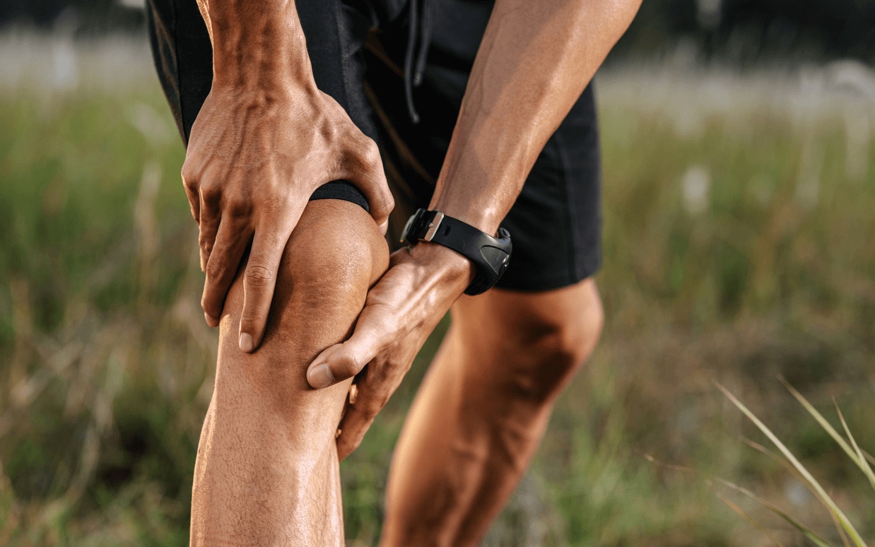 A man holds his knee in pain while out for a jog in Hoover, AL