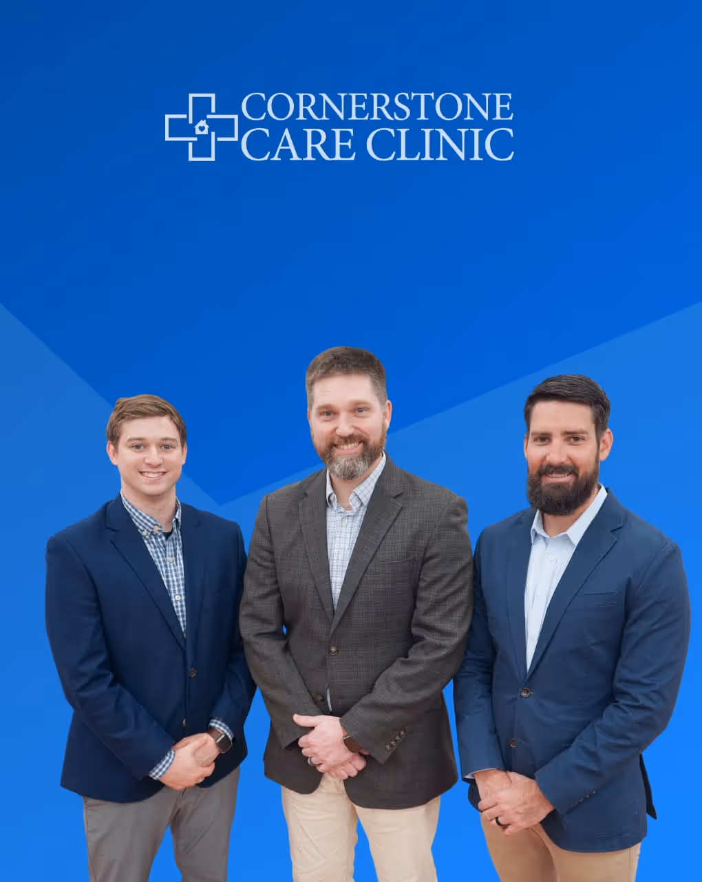 Cornerstone Care Clinic team posing professionally against blue background