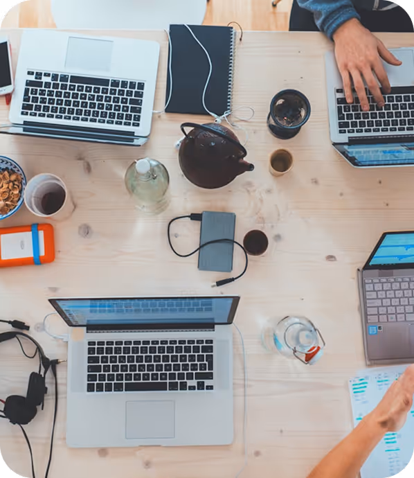 Top view of a workspace with laptops and gadgets.