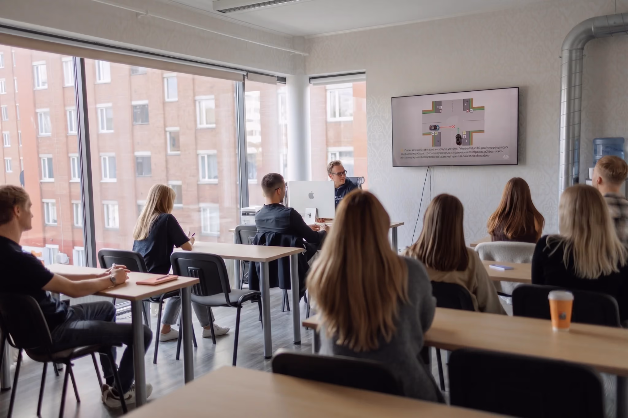 Students and theory teacher in a driving school classroom in Tallinn