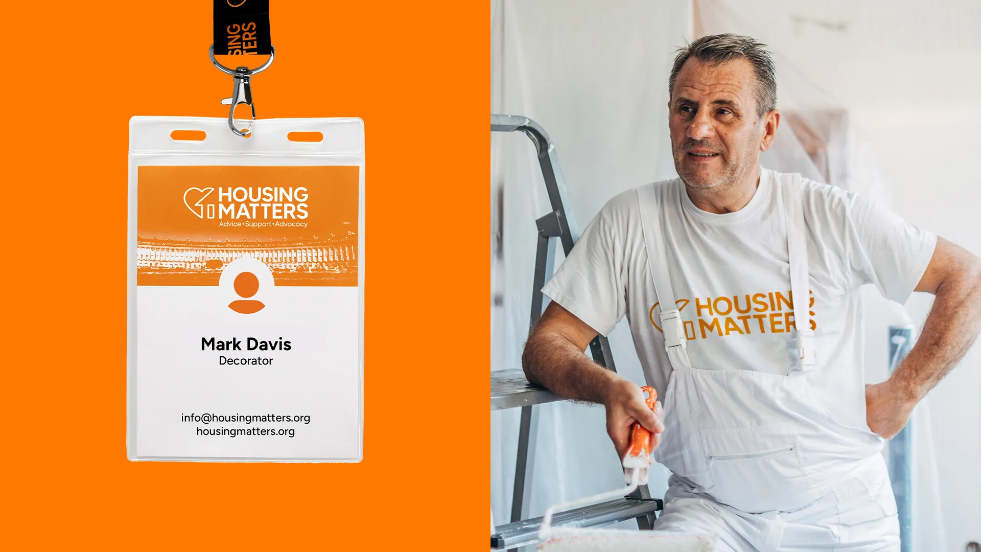 Man in white overalls with Housing Matters shirt holding a paint roller by ladder next to an orange Housing Matters lanyard.