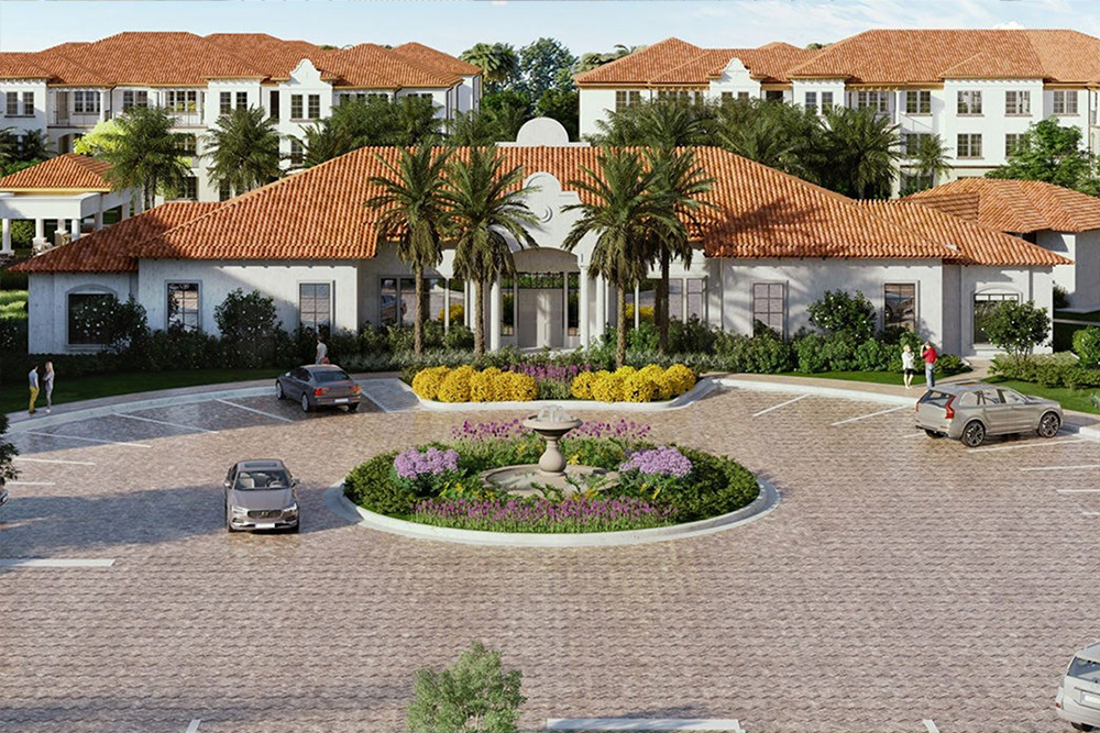 Residential complex with terracotta roofs, palm trees, central fountain, and parked cars in a paved courtyard.