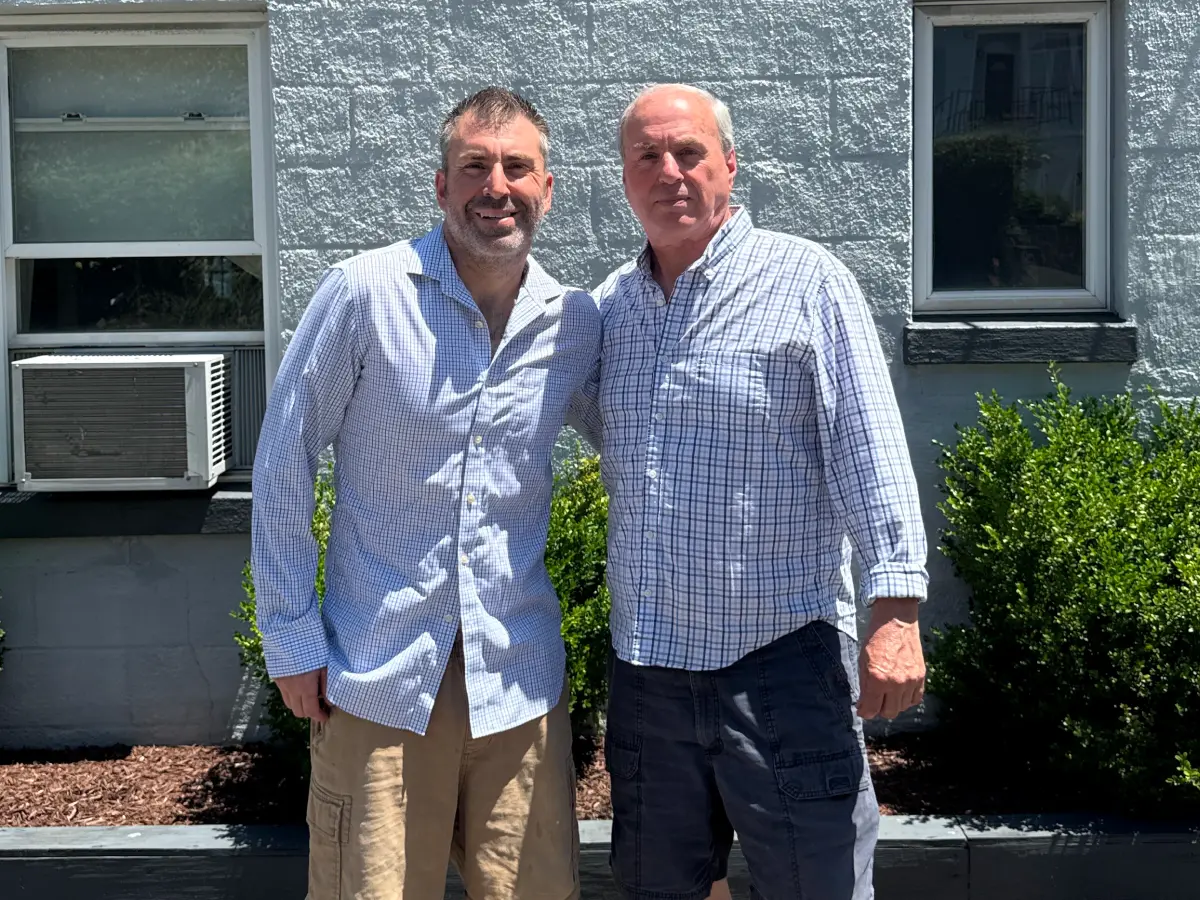 Mike Brunetto Junior standing next to Mike Brunetto Senior, both smiling.