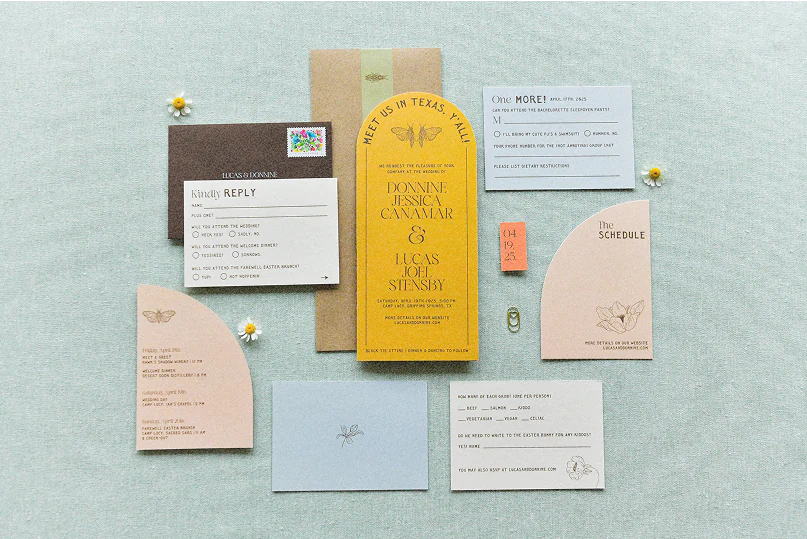 Flat lay of Donnine and Lucas's wedding invitation suite.
