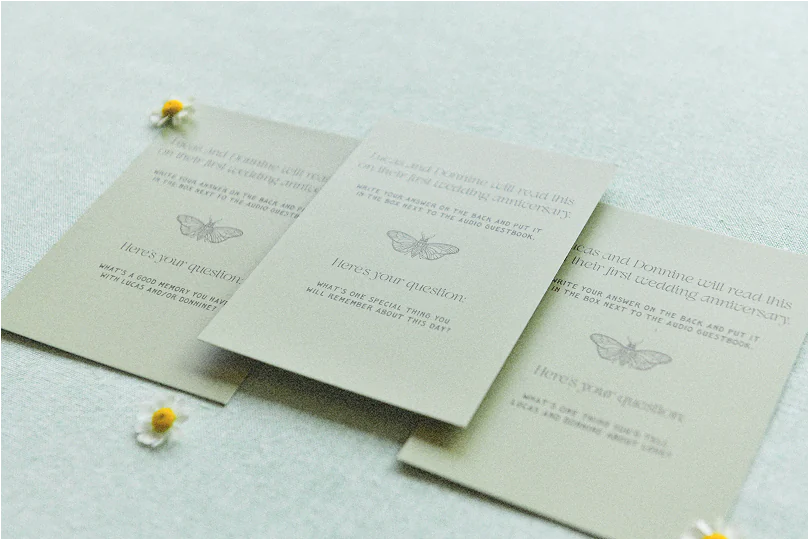 Flat lay of cards with prompts to write notes to the couple to read on their anniversary.