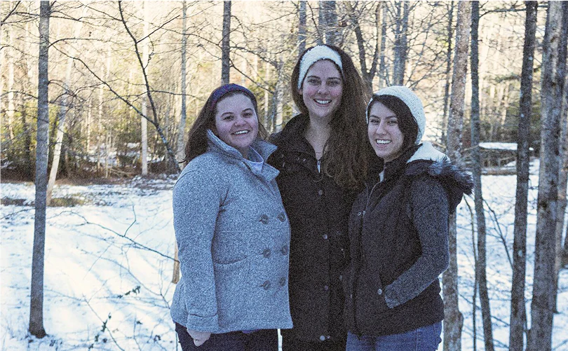 Our three founders smiling for the camera in the snowy woods.