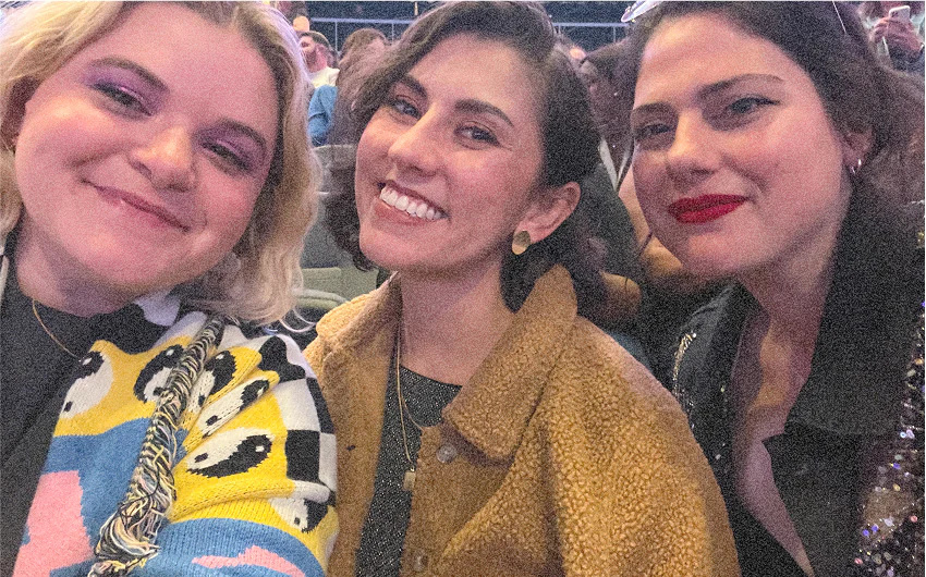 Our founders smiling at the camera at a concert.
