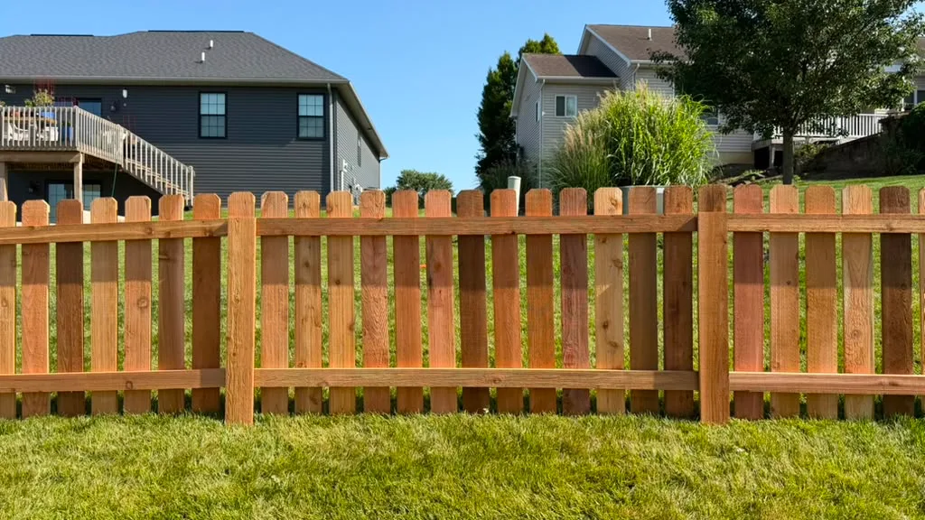 Wood fence line running the length of a residential yard
