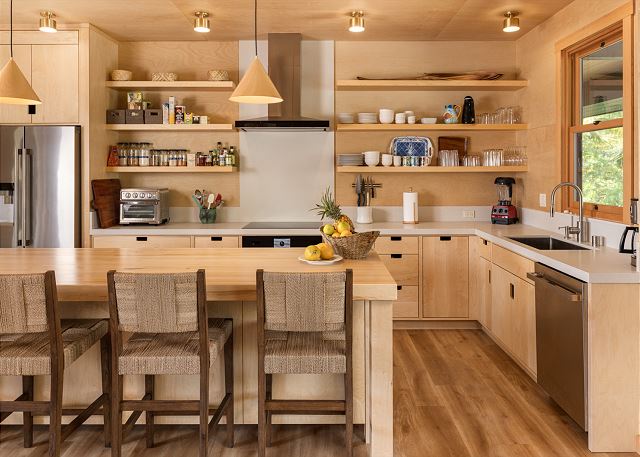 Ka Momi rental property kitchen with lots of warm wood and a clean interior