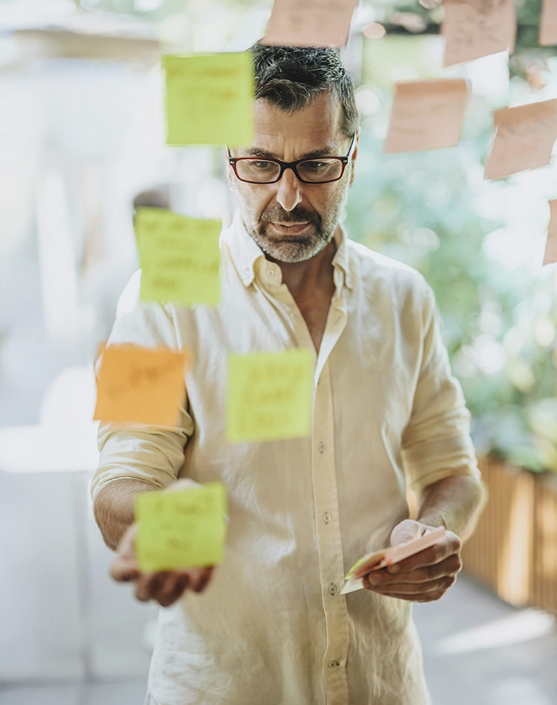 Logistics manager planning with post-it notes