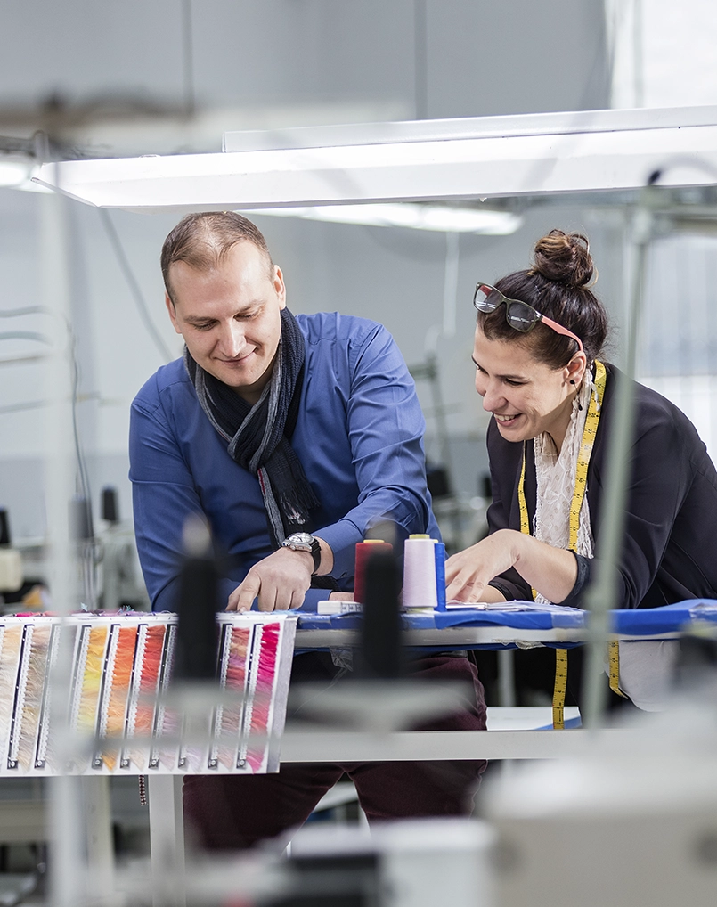 Two manufacturing colleagues setting a machine