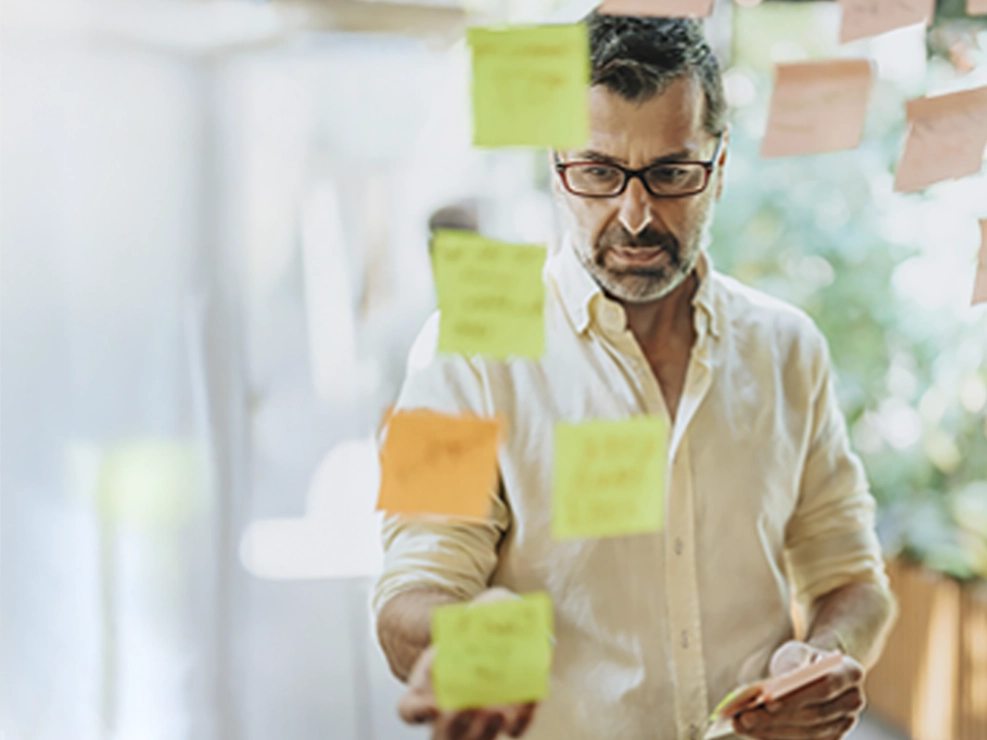 Logistics manager planning with post-it notes