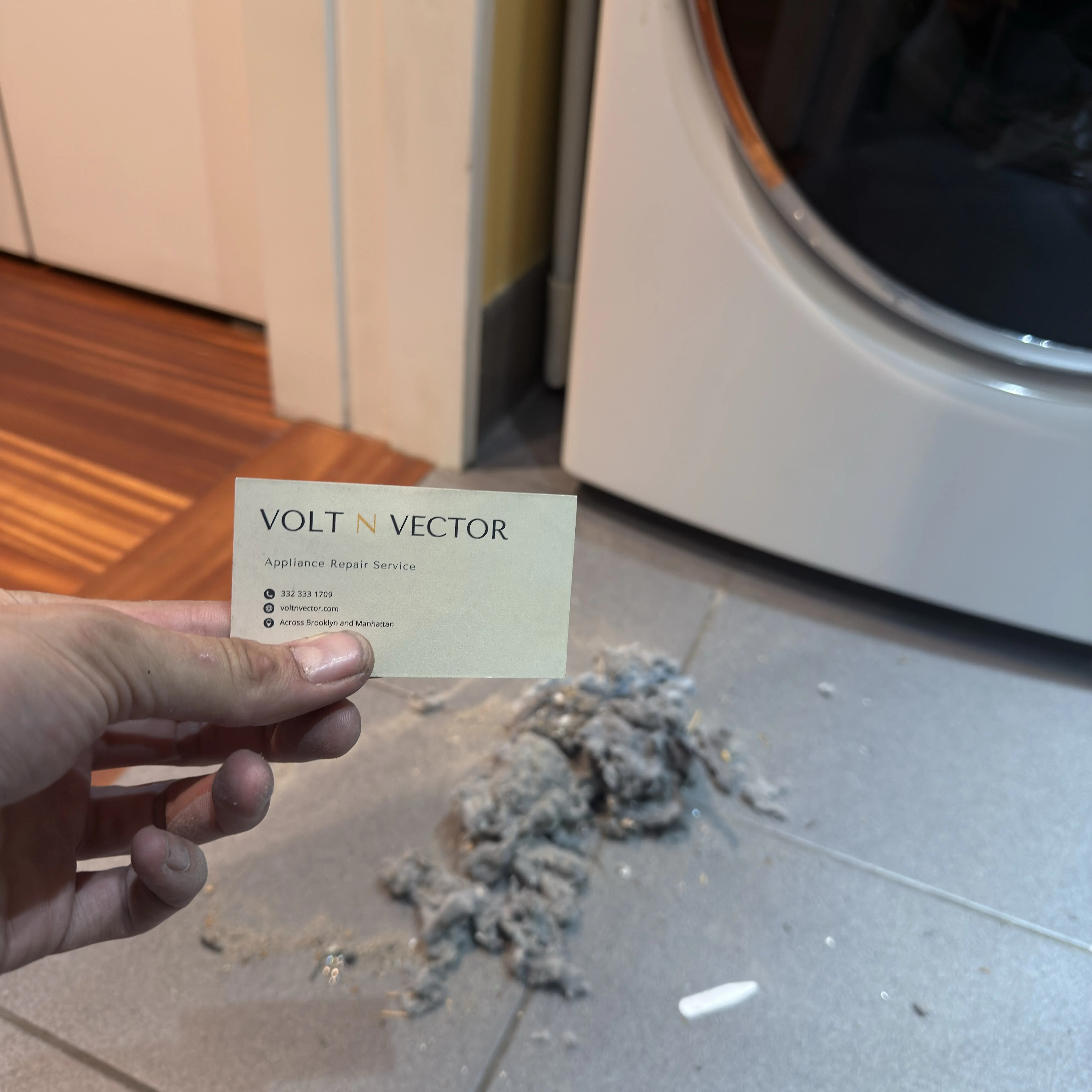 Volt N Vector business card near dryer with lint and appliance repair service