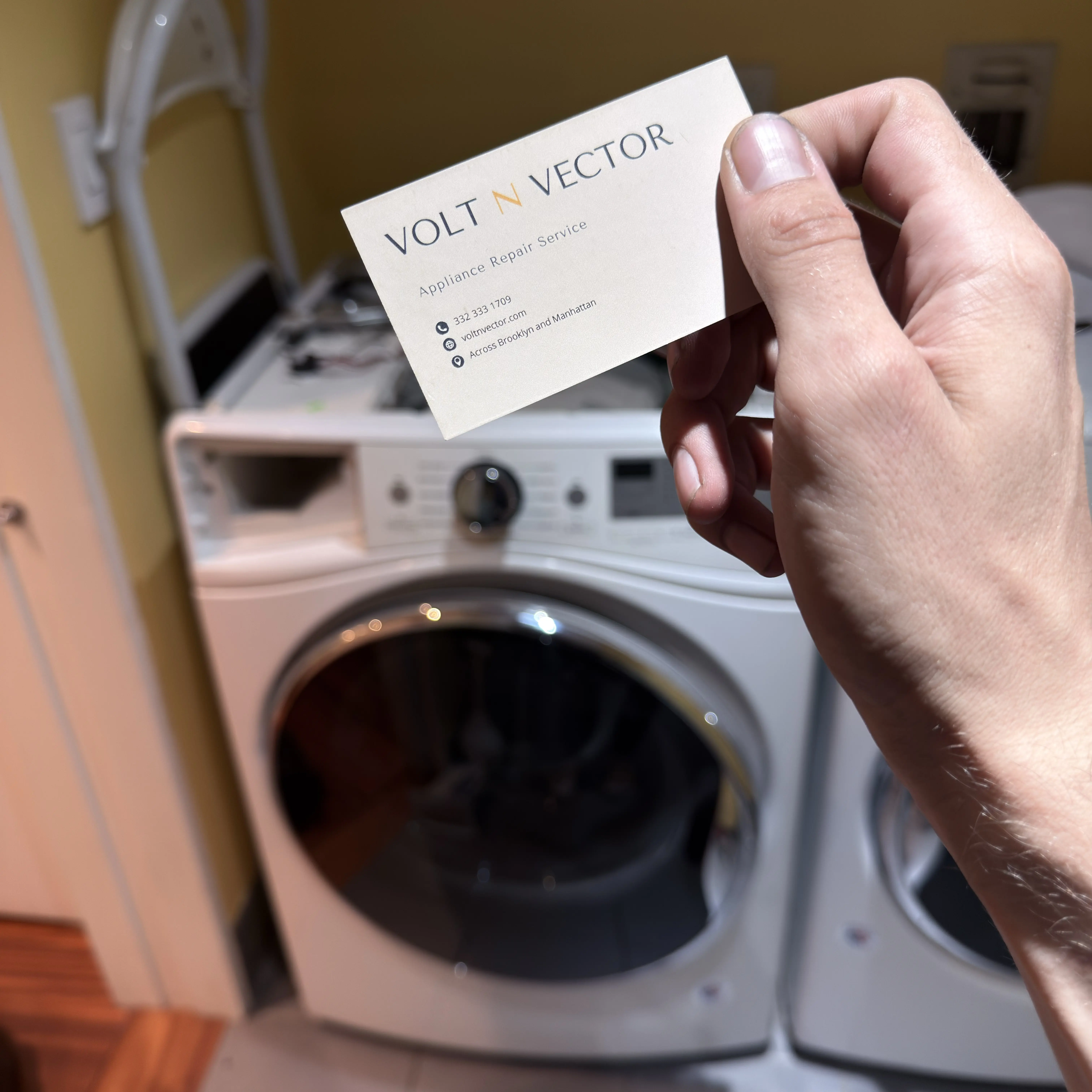 Open freezer filled with food items including ice cream tubs, boxed products, and vegetables, with a person kneeling in front of it.
