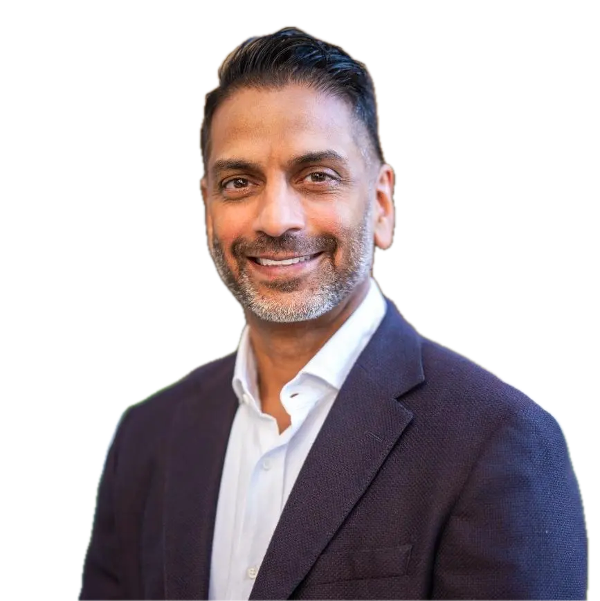 Smiling middle-aged man with beard wearing dark blazer and white shirt on transparent background.