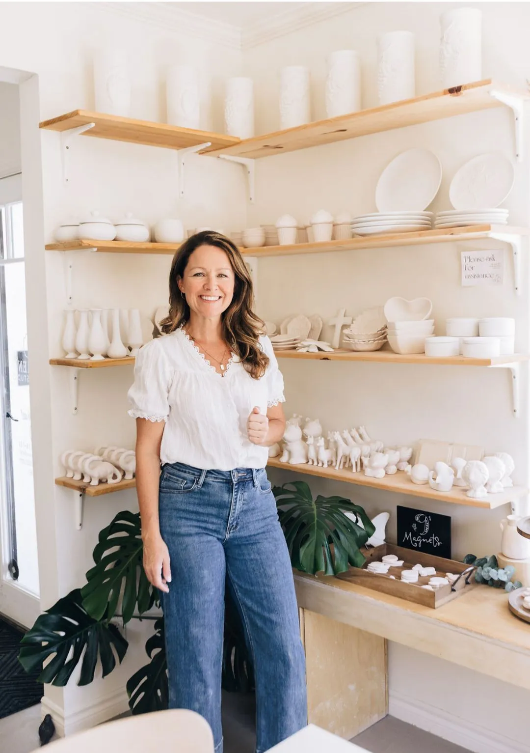 Mud Hen's owner, Jennifer, posing with pottery