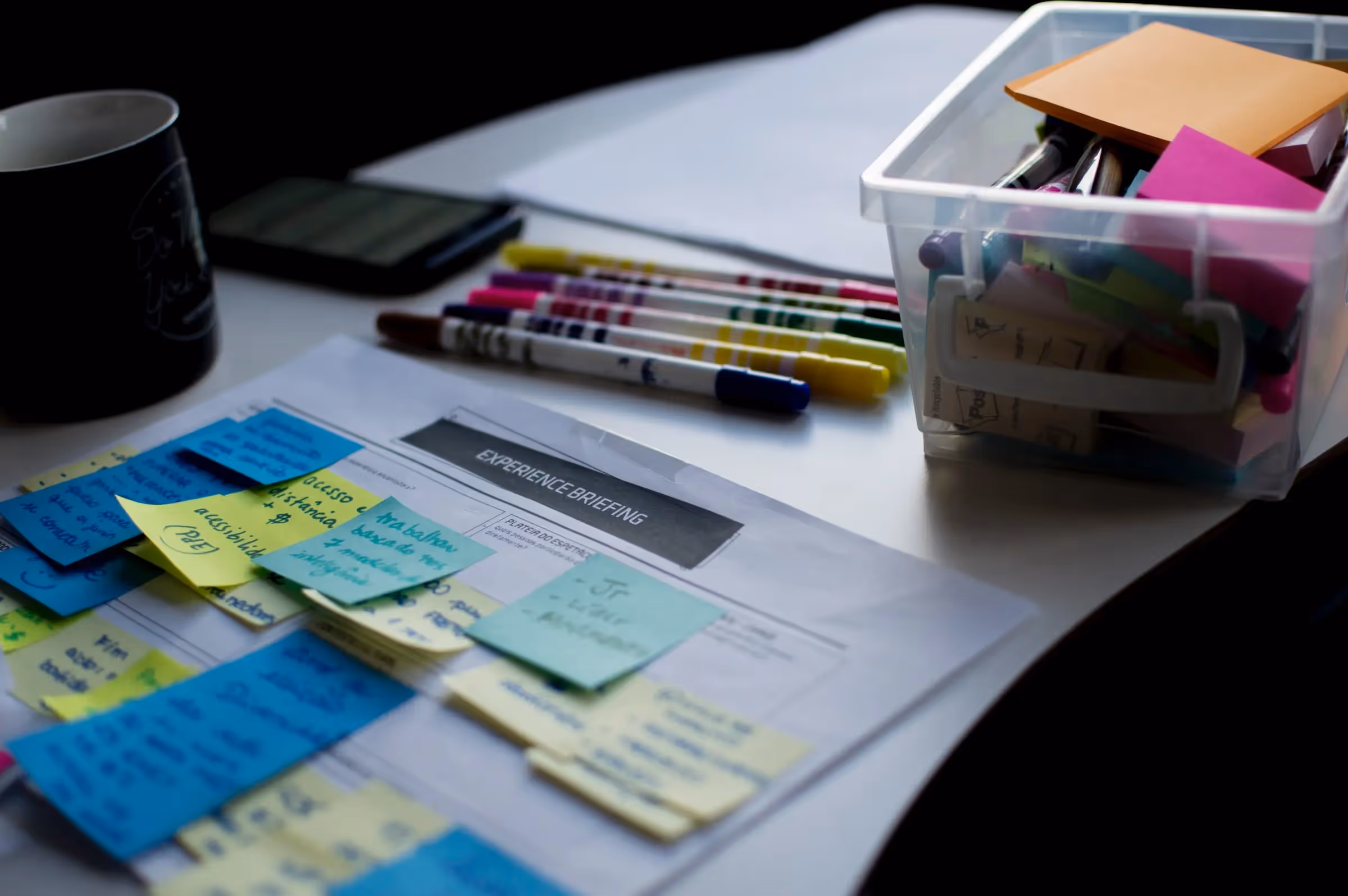 desk of a designer with post-its and markers