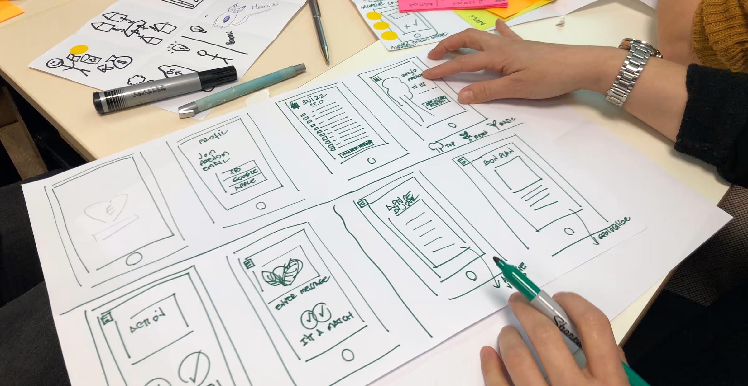 Image showing someone drawing mobile wireframe or interface.
