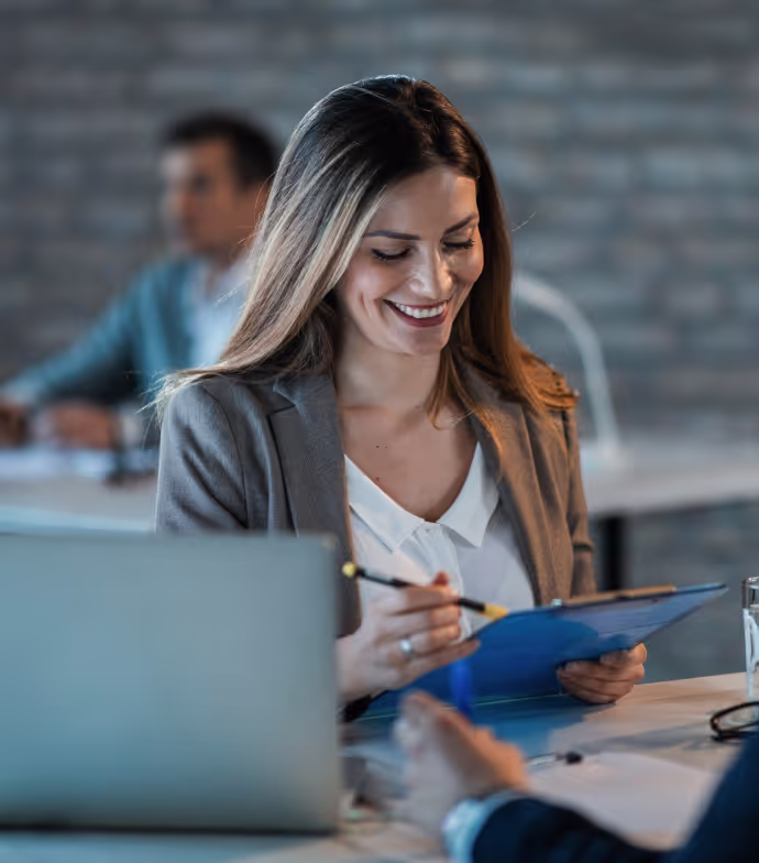 woman smiling and looking at the documents