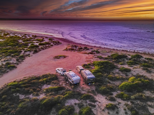 Two caravans camped off grid beside the ocean in South Australia