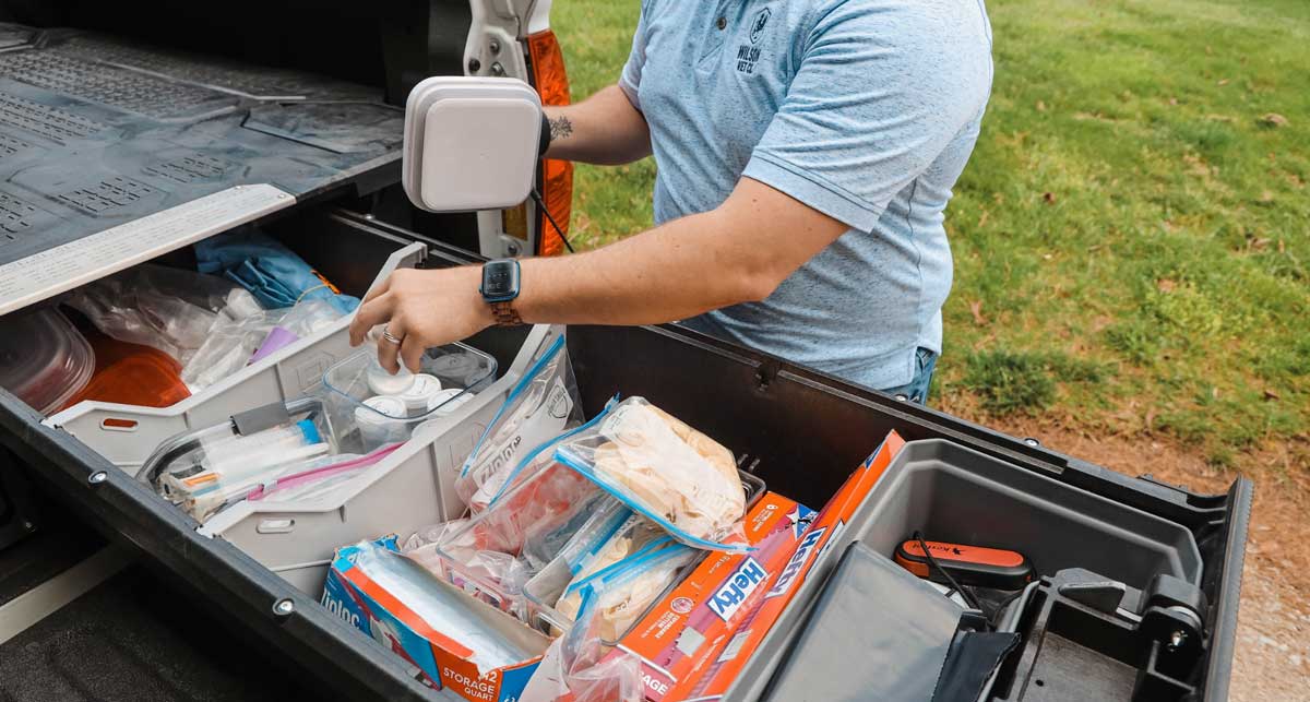 Poultry veterinarians collecting and packaging diagnostic samples for laboratory testing