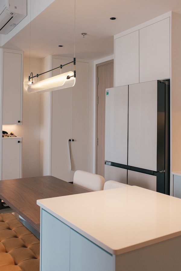 A kitchen with a white counter top and white cabinets