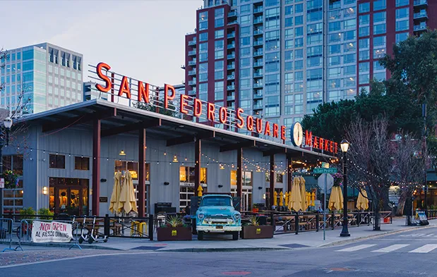 San Pedro Square Market with outdoor seating, string lights, and a vintage truck in downtown San Jose.