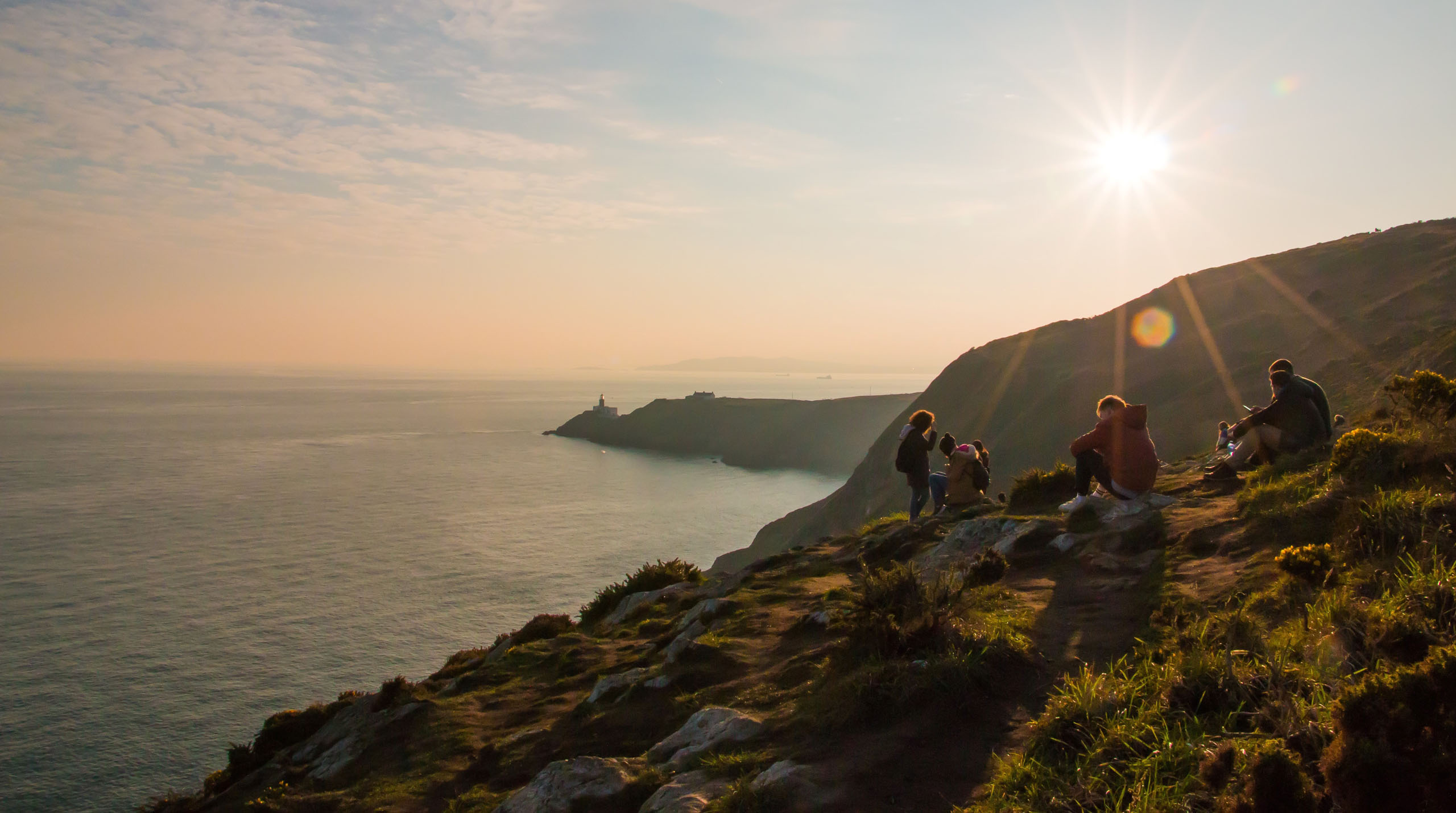 people enjoying time on cliffs looking out on the ocean