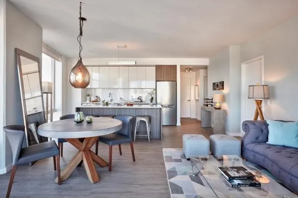 Modern open-concept living space with sleek kitchen, dining area, and cozy seating arrangement.