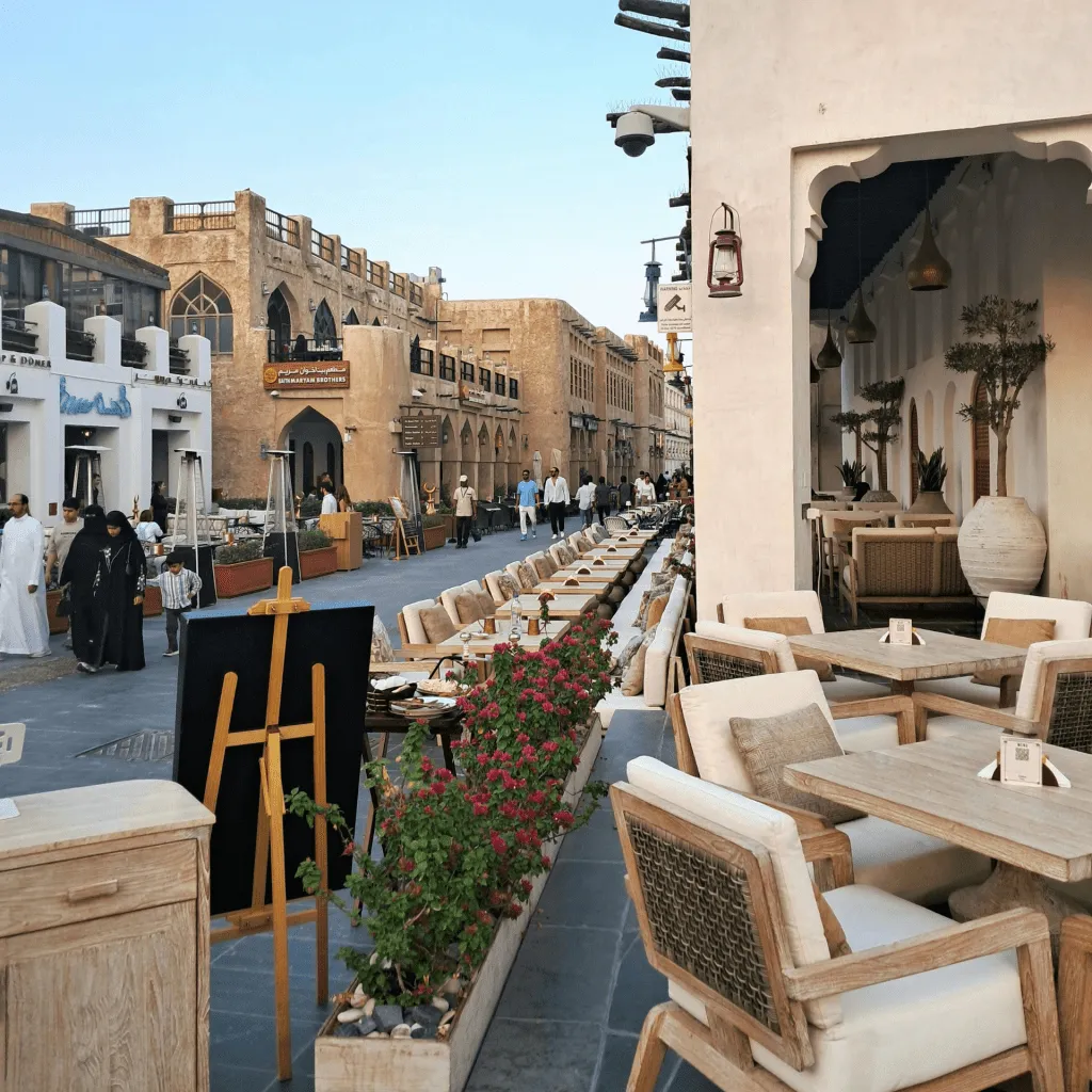 A bustling outdoor market with traditional architecture and cozy café seating arrangements.