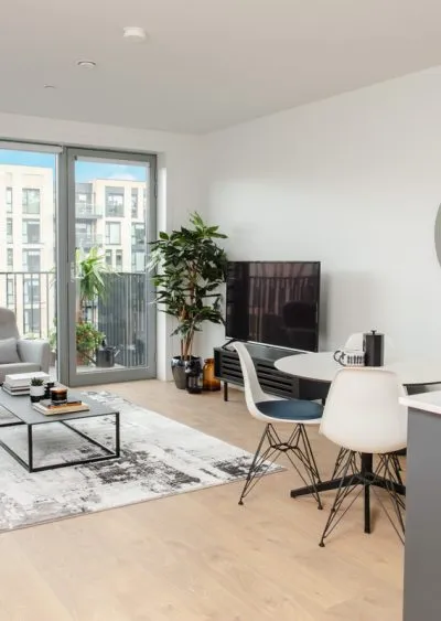 Modern living room with minimalist decor, large windows, and a mix of neutral and bold accents.