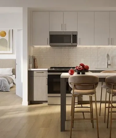 Modern kitchen with sleek cabinetry, integrated appliances, and a cozy adjoining bedroom.