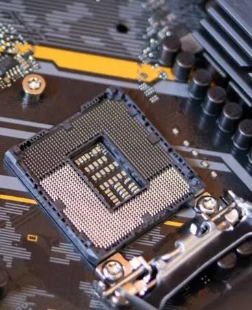 A close-up of an LGA CPU socket on a motherboard, showing pins and surrounding components.
