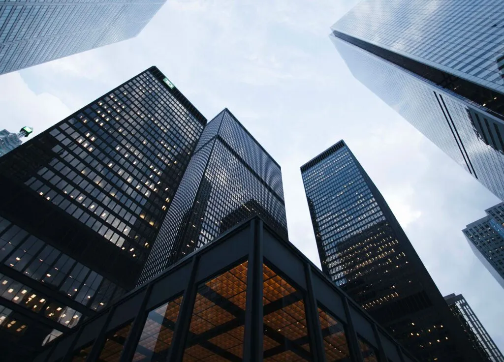 Skyscrapers tower against a cloudy sky, showcasing modern architecture and urban density.