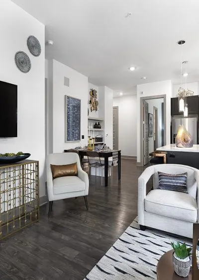 Modern living space with sleek furniture, dark wood flooring, and neutral-toned decor accents.