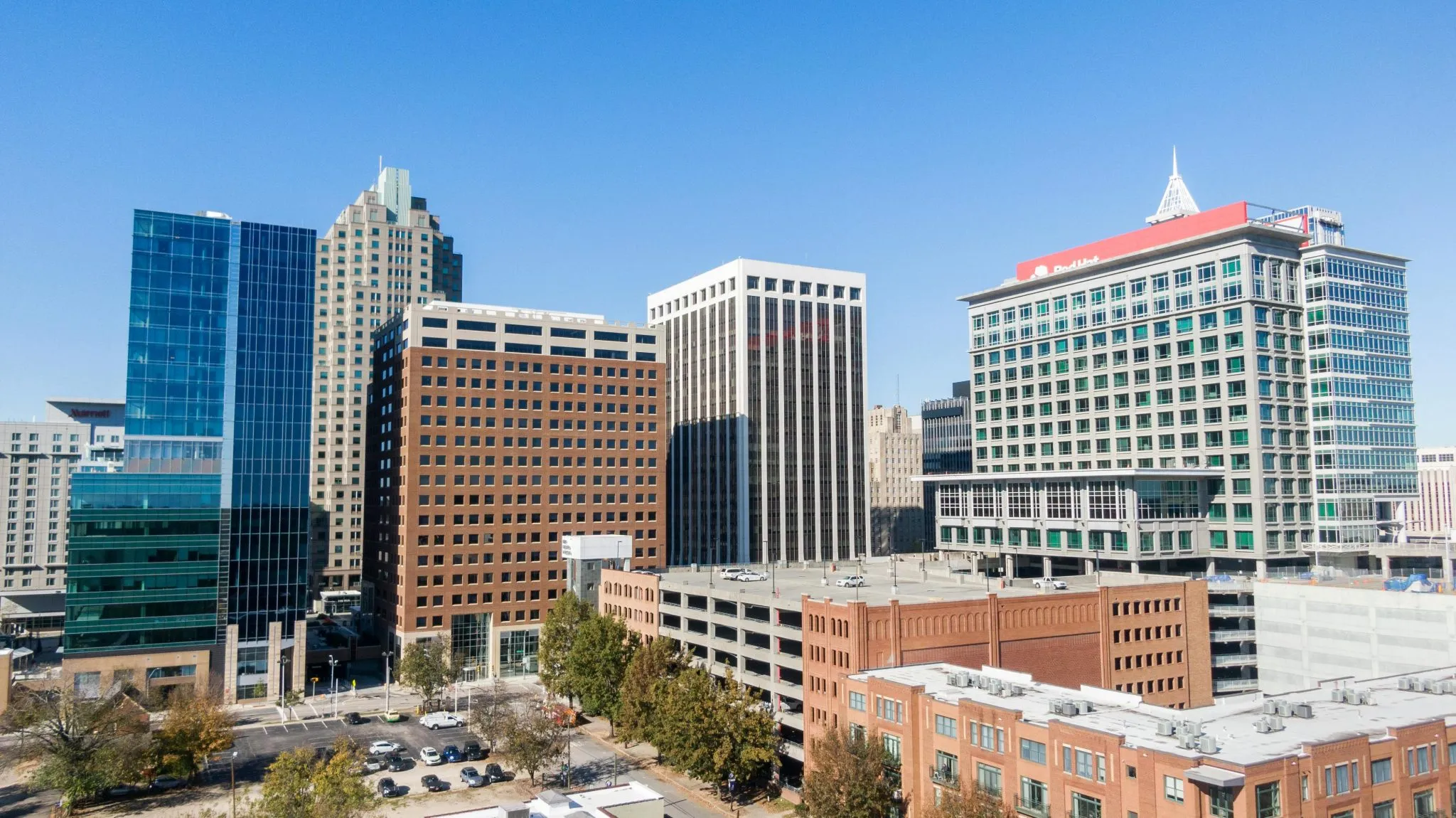 Downtown skyline featuring modern office buildings, parking structures, and urban architecture.