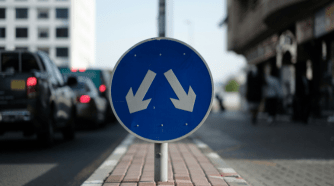 blue traffic sign with two arrows