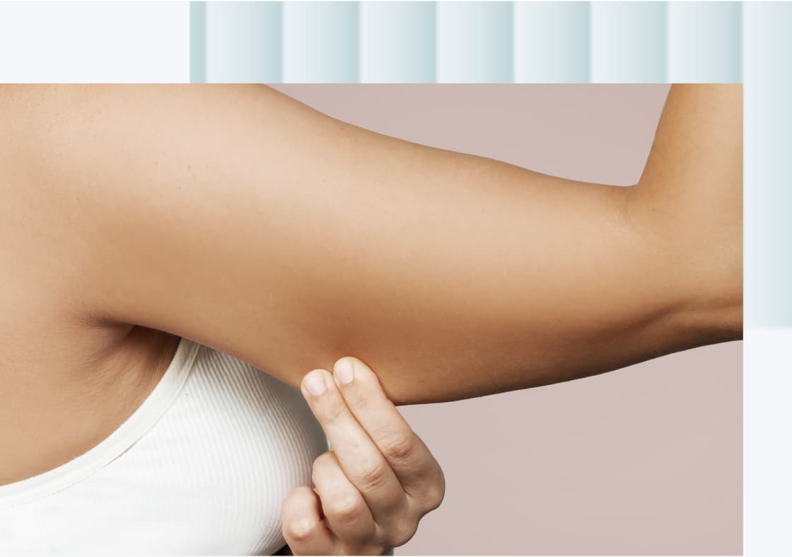 A close-up of a person's arm, showing a hand curling fingers against the outer part of the upper arm.