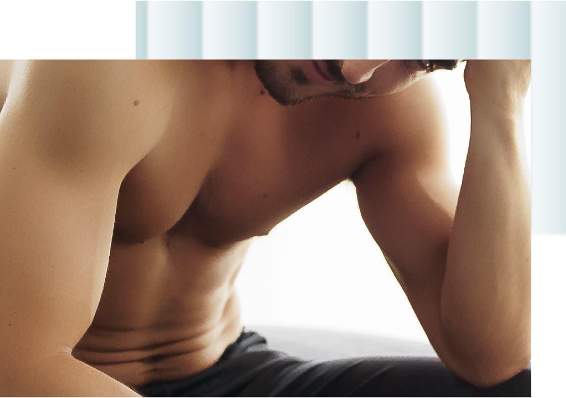 A close-up image of a male torso showing bare skin and muscular arms, with the subject resting his head on one hand, conveying a contemplative mood.