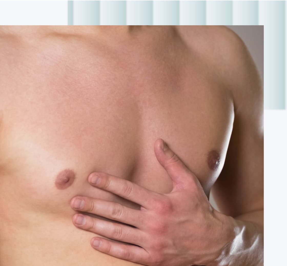 A close-up image of a man's chest with one hand placed over the left nipple.