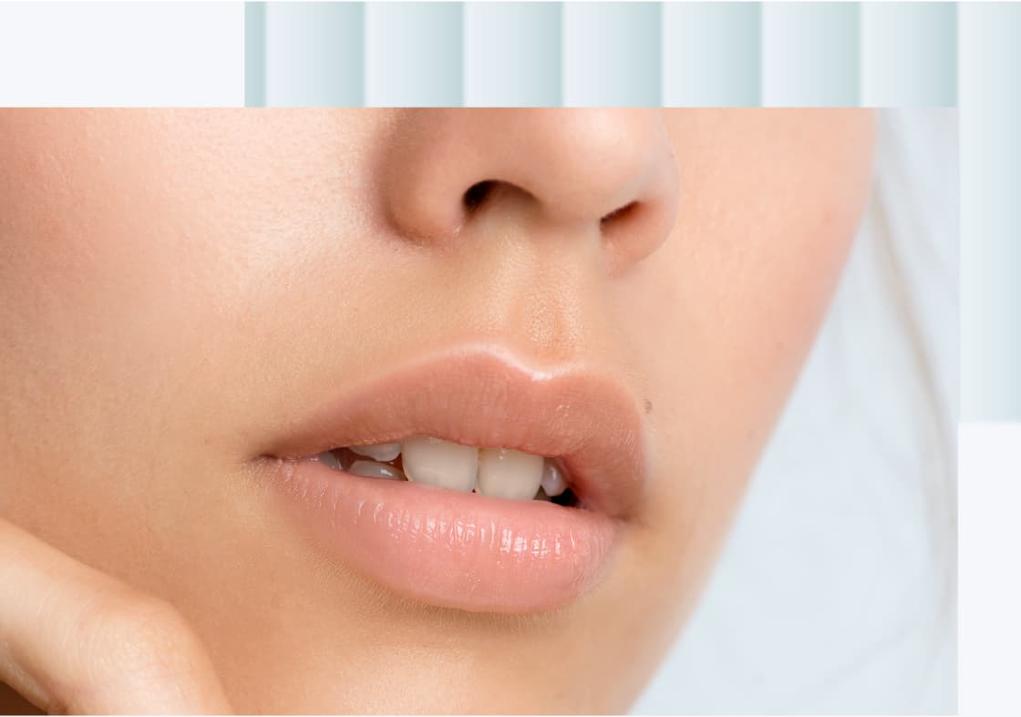 A close-up of a woman's lips and chin, showing a natural, soft lip color with a hint of shine.