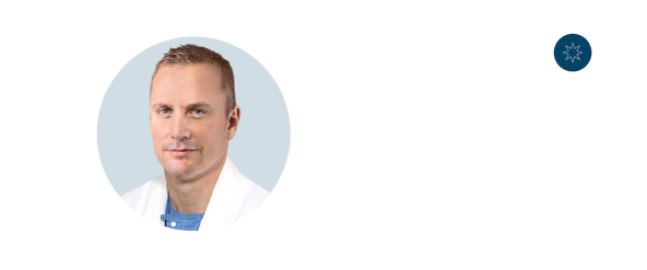 A round photo of a man in a white coat, with short light hair and a slight smile, next to a dark blue starburst icon.