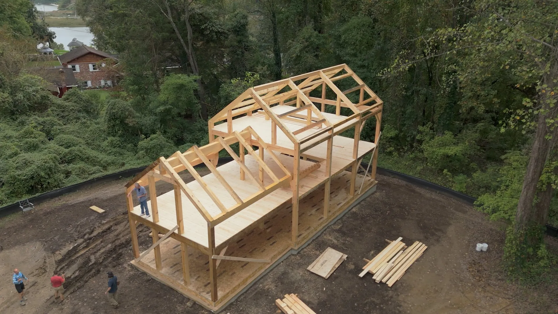 Wooden frame of a building under construction in a wooded area