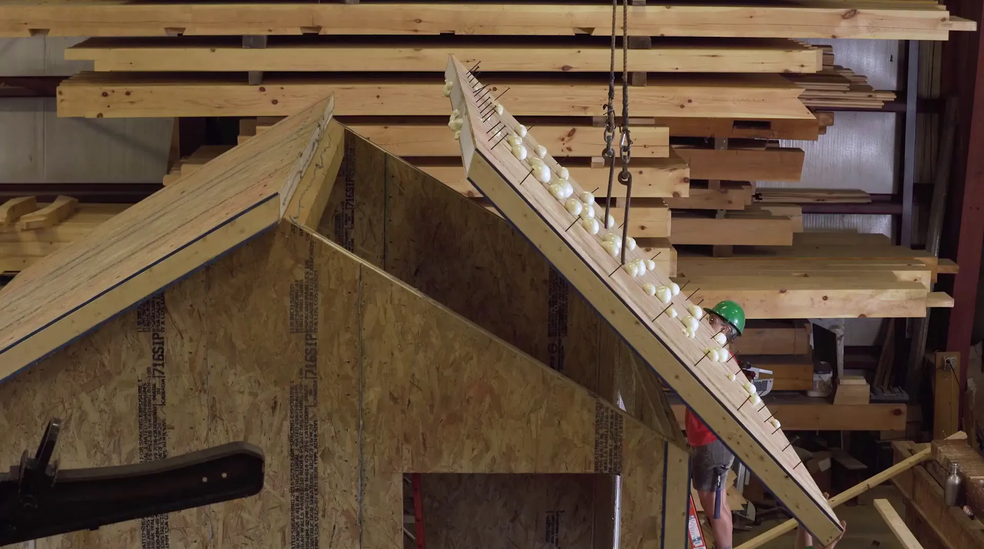 Wooden conveyor with white eggs moving through industrial lumber storage room